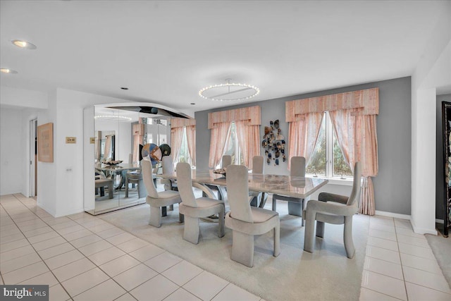 dining space featuring a wealth of natural light, baseboards, and light tile patterned flooring