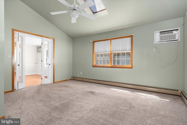 unfurnished bedroom featuring lofted ceiling with skylight, a wall unit AC, connected bathroom, carpet flooring, and baseboard heating