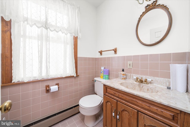 bathroom featuring toilet, a baseboard heating unit, tile walls, wainscoting, and vanity