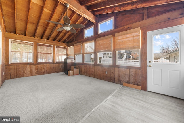 sunroom / solarium featuring lofted ceiling with beams, ceiling fan, and wooden ceiling