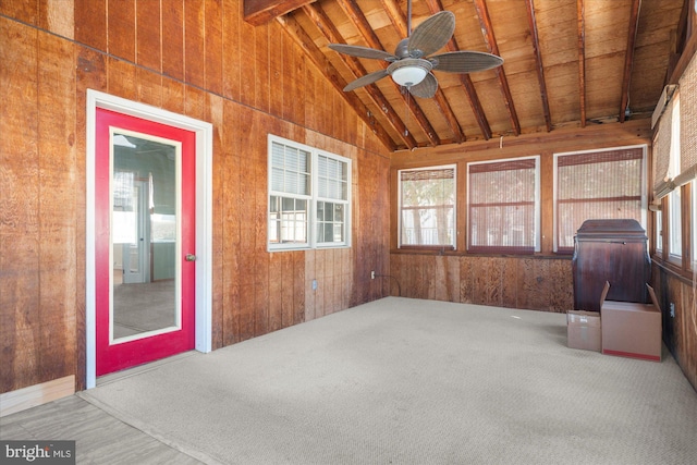 unfurnished sunroom with lofted ceiling with beams, wood ceiling, and ceiling fan