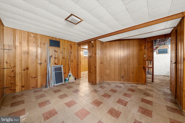 finished basement featuring wooden walls and visible vents