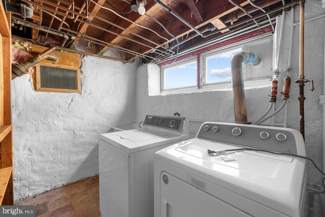 clothes washing area featuring laundry area and washing machine and dryer