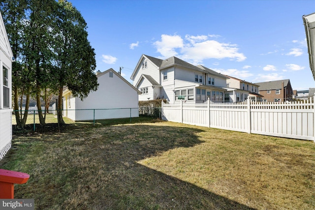 view of yard featuring a residential view and a fenced backyard