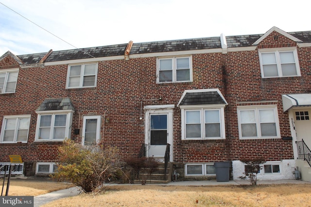 view of property with brick siding and entry steps