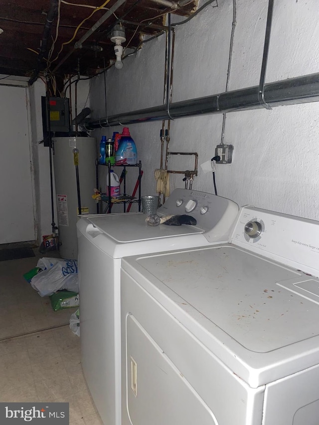 washroom featuring gas water heater, laundry area, and washer and clothes dryer