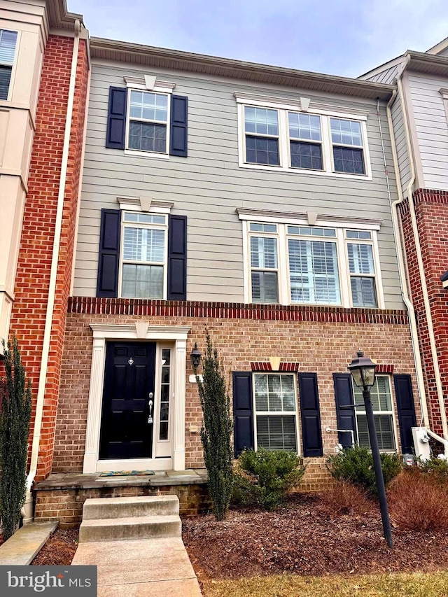 view of property featuring brick siding