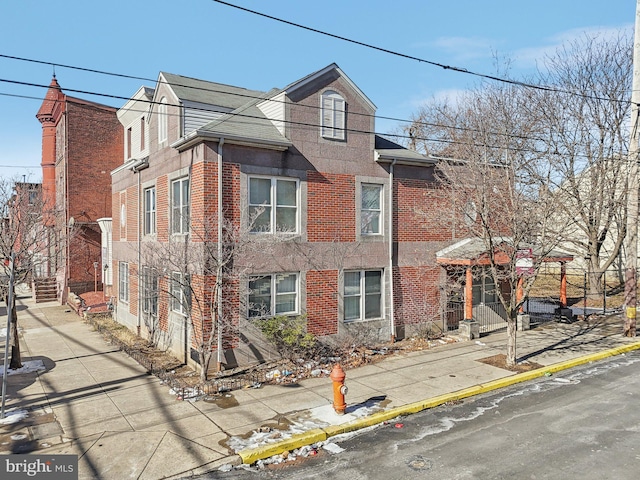 townhome / multi-family property featuring brick siding