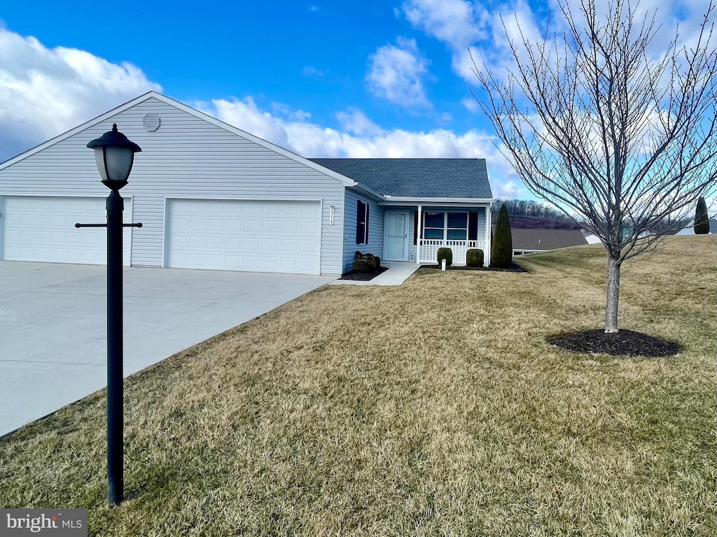 ranch-style home with an attached garage, covered porch, concrete driveway, and a front lawn