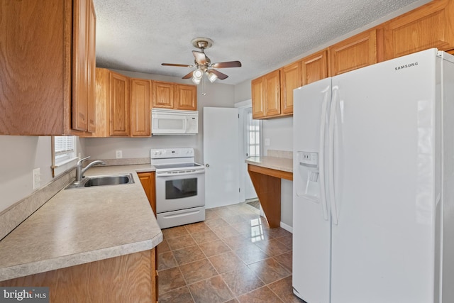 kitchen with ceiling fan, light countertops, white appliances, a textured ceiling, and a sink