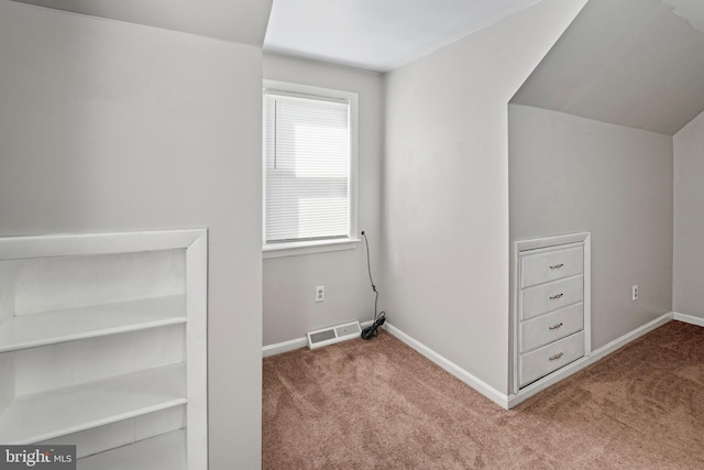 interior space featuring baseboards, carpet floors, and visible vents