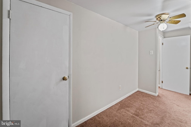 unfurnished bedroom featuring baseboards, a ceiling fan, and carpet flooring