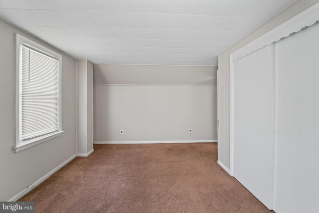 unfurnished bedroom with carpet flooring and baseboards