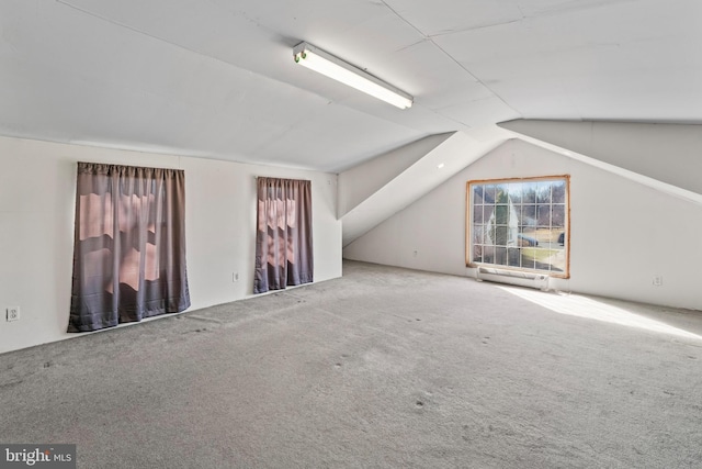 additional living space with vaulted ceiling and carpet