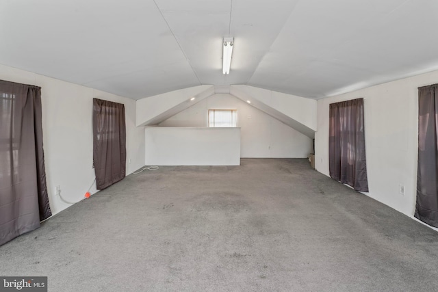 bonus room featuring lofted ceiling and carpet floors