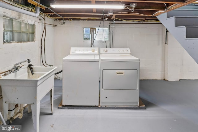 laundry room featuring laundry area, separate washer and dryer, and a sink