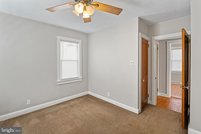 unfurnished bedroom featuring baseboards, carpet floors, and ceiling fan