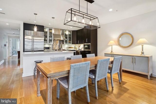 dining area with recessed lighting, baseboards, and light wood-style flooring