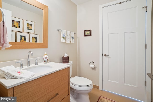 bathroom with tile patterned floors, toilet, and vanity