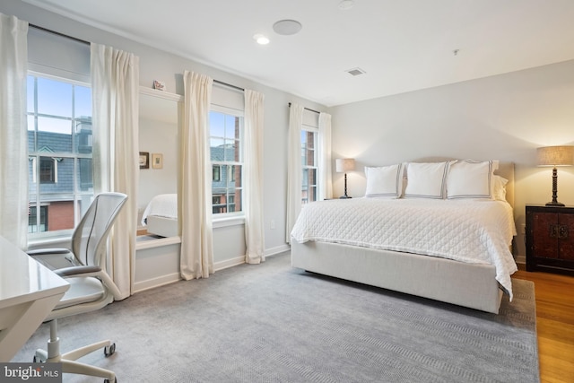 bedroom with baseboards and visible vents