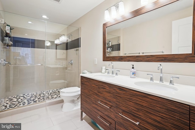 full bath with a sink, toilet, a stall shower, and tile patterned flooring