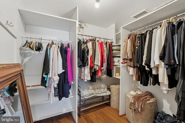 walk in closet featuring visible vents and wood finished floors