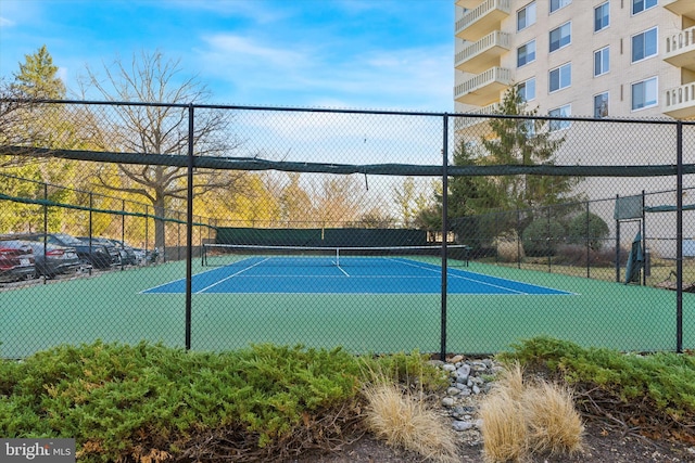 view of tennis court with fence