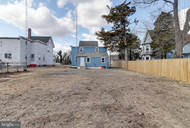 back of house featuring fence