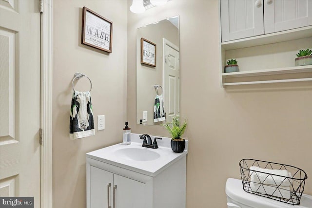 bathroom featuring toilet and vanity