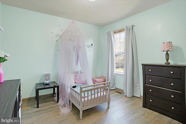 bedroom with baseboards and light wood-type flooring