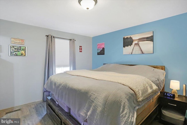 bedroom with wood finished floors and visible vents