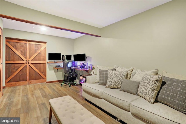 living area with baseboards and wood finished floors