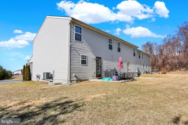 back of house featuring cooling unit and a yard