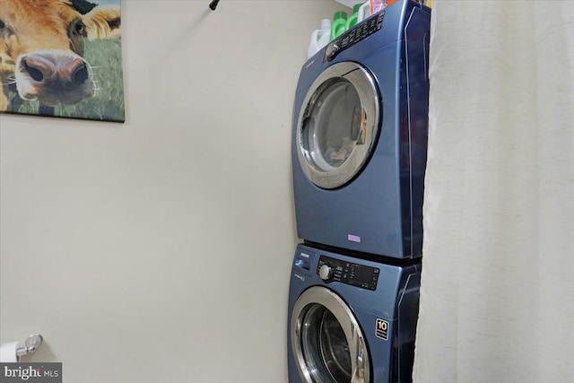 laundry room featuring laundry area and stacked washer / drying machine