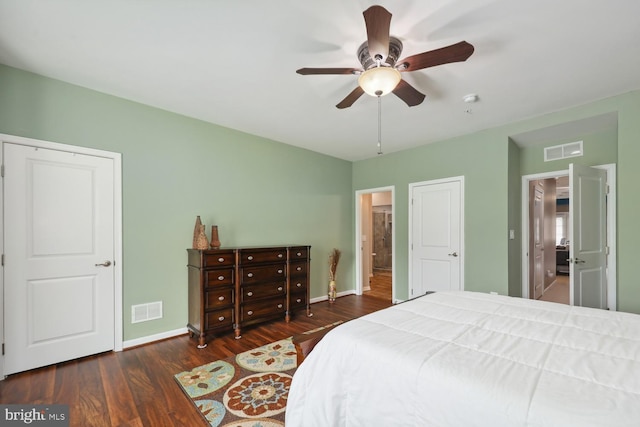 bedroom featuring wood finished floors, visible vents, and baseboards