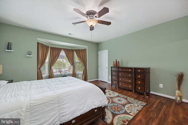 bedroom with wood finished floors, a closet, baseboards, visible vents, and a ceiling fan