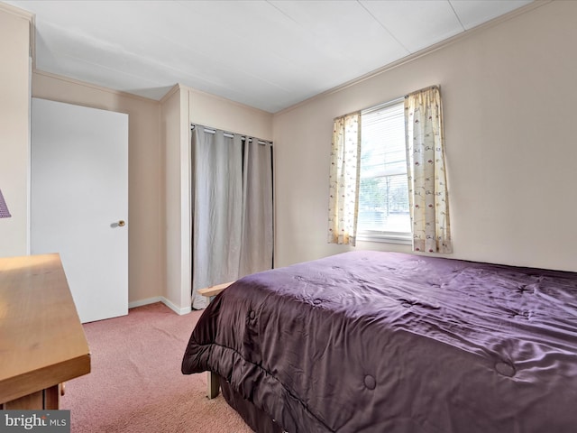 carpeted bedroom featuring baseboards and ornamental molding