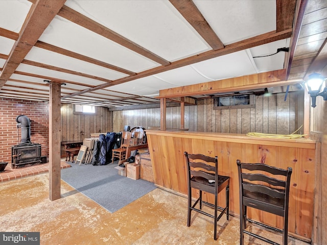 bar with wooden walls and a wood stove