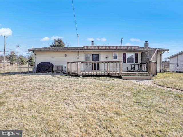 rear view of house featuring a yard, fence, cooling unit, and a wooden deck