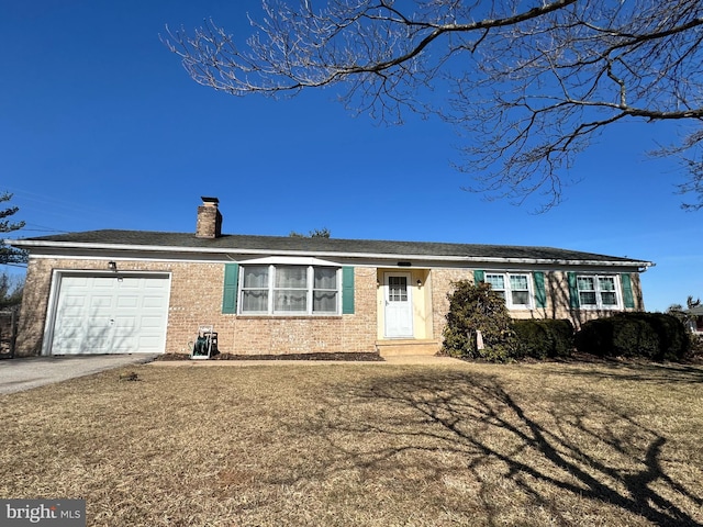 single story home featuring a garage, driveway, brick siding, and a chimney