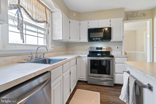 kitchen featuring a sink, light countertops, white cabinets, and stainless steel appliances