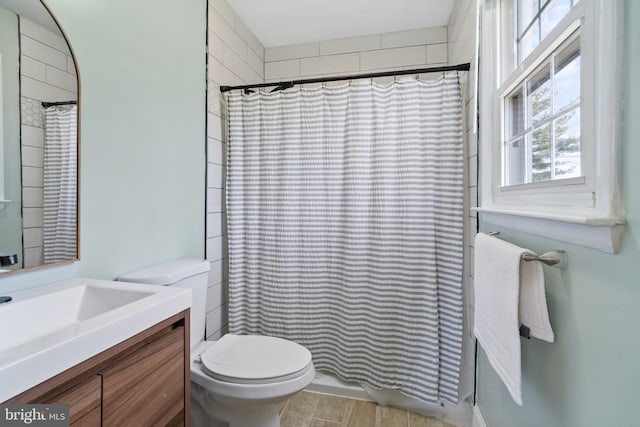 bathroom featuring vanity, toilet, and a shower with curtain