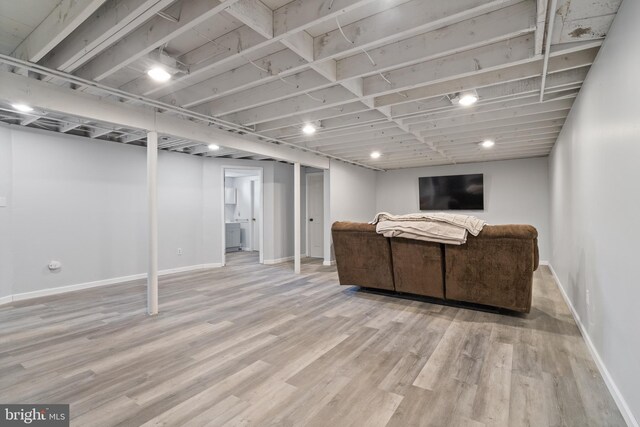 unfurnished living room with wood finished floors and baseboards