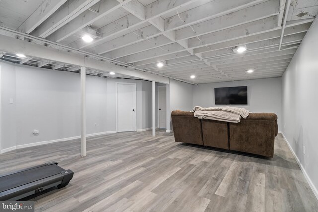 interior space with baseboards and wood finished floors