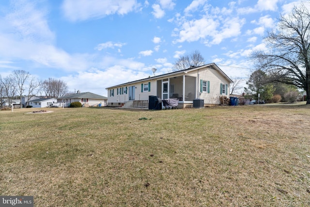 exterior space with central AC and a front lawn