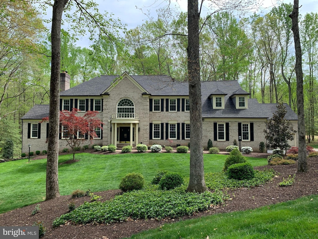 view of front of home with a front lawn and a chimney