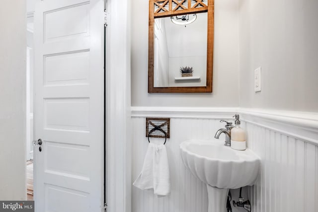 bathroom featuring a sink and wainscoting