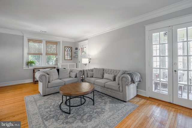 living area featuring french doors, hardwood / wood-style floors, baseboards, and ornamental molding