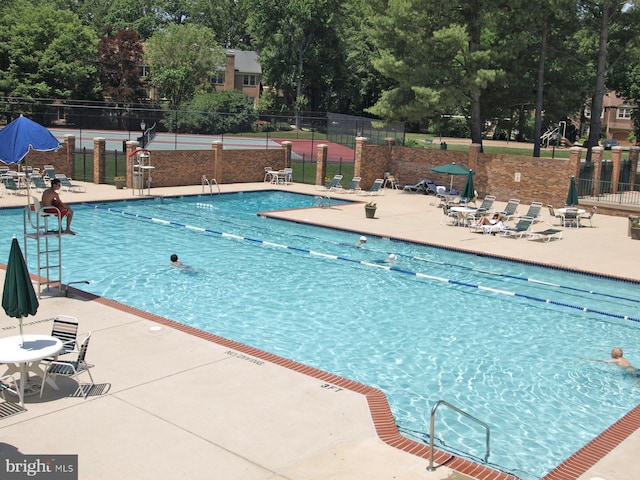 11305 Commonwealth Dr Unit 302, Rockville, MD 20852 - community pool featuring a patio area and view of scattered trees