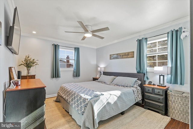 bedroom featuring baseboards, crown molding, a ceiling fan, and wood finished floors